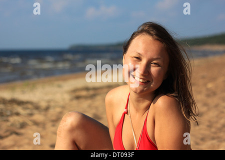 Divertente faccia mare spiaggia di giovane donna asiatica abbronzatura felice conciate bikini estate sorride allegro brunette ritratto Foto Stock