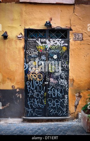 Graffiti spruzzato su portali in Trastevere, Roma, Italia. Foto Stock