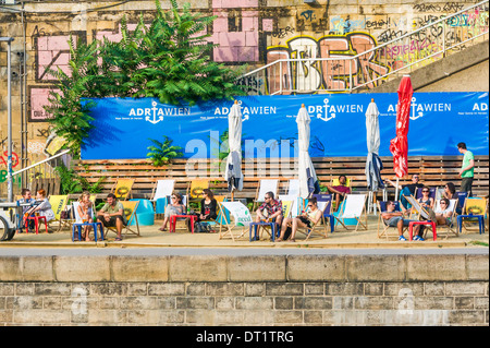 I giovani per rilassarsi dopo il lavoro al  adriawien  beach cafe sulle rive del canale del Danubio, Vienna, Austria Foto Stock