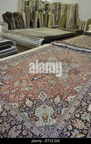 tappeti orientali, molti fatti a mano e antichi, provenienti da diversi paesi, in mostra in un negozio di tappeti Canada Foto Stock