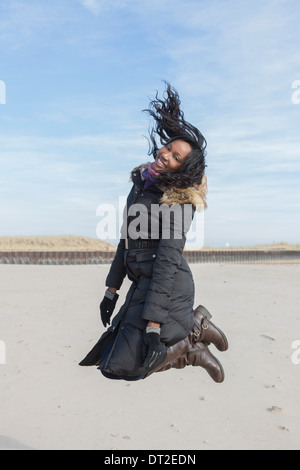 Stati Uniti d'America, Illinois, Waukegan, giovane donna salto sulla spiaggia Foto Stock