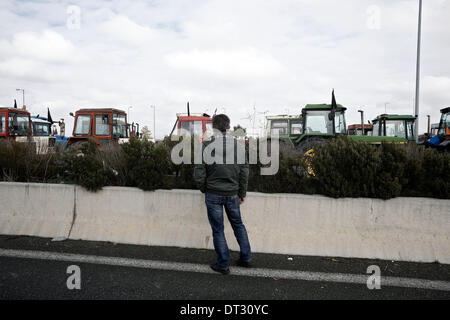 Nikaia, Larissa, Grecia. 7 febbraio 2014. Gli agricoltori cercano di bloccare l'autostrada tra Salonicco e Atene in Nikaia, circa 380 km a nord di Atene. Protesta degli agricoltori greci, che chiedono agevolazioni fiscali e di altri benefici, hanno rifiutato un offerta da parte del governo greco dopo un febbraio 6 sale riunioni e ci hanno detto che non avrebbe relent e mantenere i loro trattori posizionati in corrispondenza di punti chiave sulle strade principali in tutta la Grecia, che hanno continuamente minacciato di bloccare a meno che essi non siano di ottenere tutto ciò che vogliono. Nikaia, Grecia nel febbraio 7, 2014. Credito: Konstantinos Tsakalidis/Alamy Live News Foto Stock