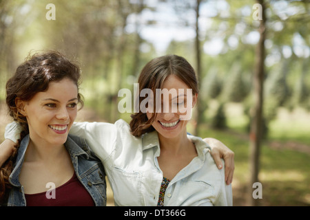 Due ragazze sorridenti di amici con le loro braccia intorno a ciascun altro Foto Stock