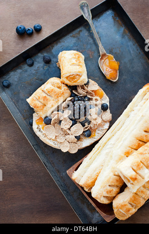 Pasties e cereali per la colazione sul vassoio da forno Foto Stock