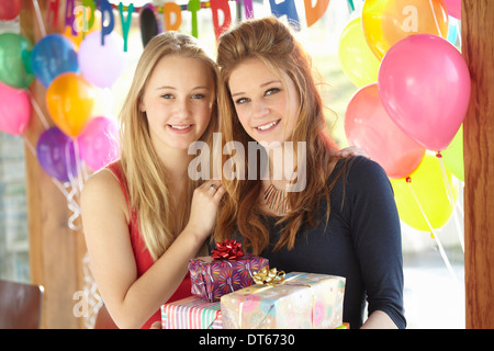 Due ragazze adolescenti condivisione dei doni alla festa di compleanno Foto Stock