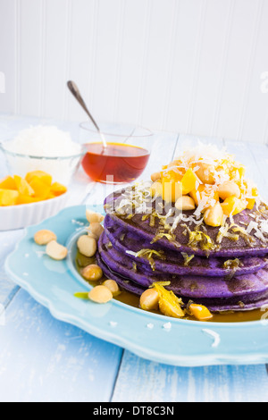 Frittelle di Taro e rabboccato con mango, noci macadamia, cocco grattugiato e sciroppo di lilikoi Foto Stock