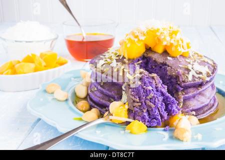 Frittelle di Taro e rabboccato con mango, noci macadamia, cocco grattugiato e sciroppo di lilikoi Foto Stock