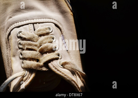 Corda di bianco sneakers in sfondo nero Foto Stock