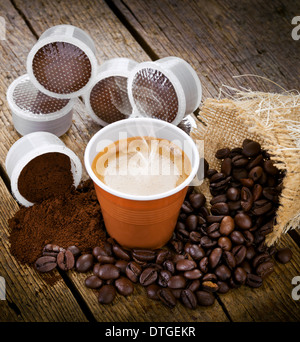 Caffè espresso in tazza monouso con cialde sul tavolo di legno Foto Stock