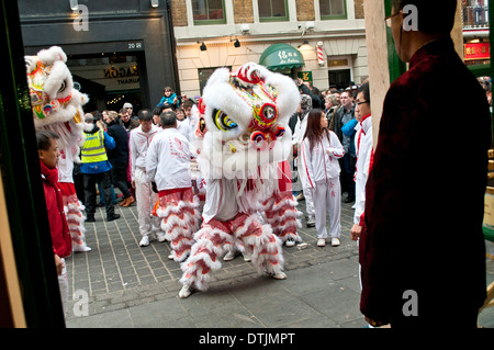 La danza del Leone, cinese tradizionale custom creduto di portare fortuna per il nuovo anno cinese, Chinatown, Soho, Londra, WC2, Regno Unito Foto Stock