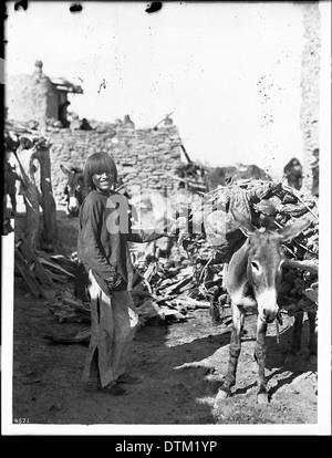 Sorridente Hopi Indian boy e il suo burro tirare legno, Arizona, ca.1898 Foto Stock