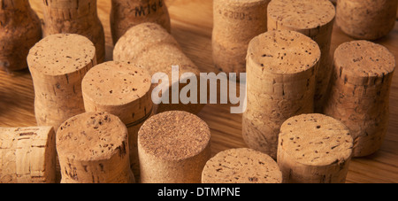 Una collezione di tappi di champagne su un piano di lavoro in legno di quercia Foto Stock