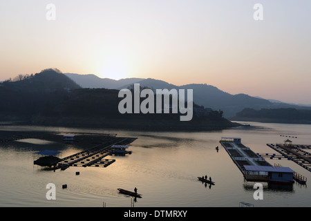 Paesaggio di barche flottante a Lakeside al tramonto Foto Stock