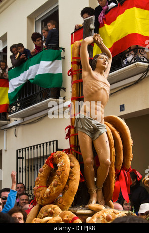 Una statua di San Sebastiano portata attraverso le strade al Fiesta del Pan (Festival del santo pane) in balsicas, Spagna. Foto Stock