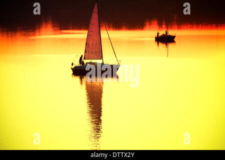 Barca a vela al tramonto Foto Stock