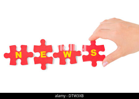 Mano e puzzle News Foto Stock