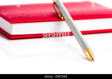 Notebook rosso con penna argento Foto Stock