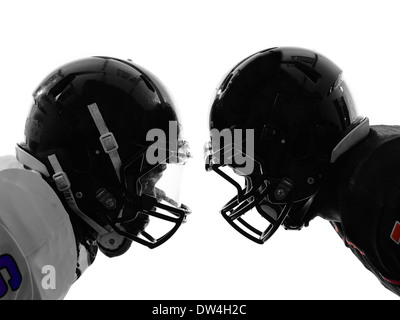 Due american football giocatori faccia a faccia in silhouette ombra su sfondo bianco Foto Stock