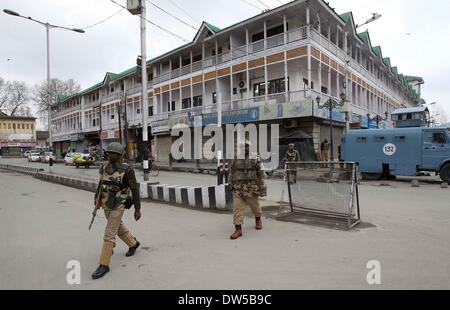 Srinagar Kashmir. 28 feb 2014. Indiano troopers paramilitari a piedi in un mercato chiuso posto durante sciopero a Srinagar, capitale estiva di Indiano-Kashmir controllato, il 28 febbraio, 2014. In caso di arresto del sistema è stata osservata con la maggioranza musulmana aree di Indiano-Kashmir controllato in scia della chiamata data dal Kashmir gruppi separatisti in cerca di identificazione di sette militanti sospetti uccisi da esercito indiano il lunedì nel distretto di Kupwara, circa 125 km a nord-ovest di Srinagar città. La protesta è scoppiata nella zona dopo la presunta di civili uccisi gli uomini ad essere civili. Credito: Xinhua/Alamy Live News Foto Stock