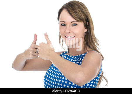 Bella giovane donna caucasica che indossa Blue Polka Dot Dress, gesturing con un felice positivo Thumbs Up, celebrando il successo, isolato su bianco Foto Stock