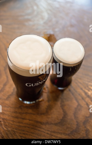 Una pinta e una mezza pinta di birra scura, Belfast, Irlanda Foto Stock