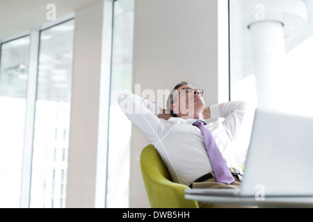 Rilassata imprenditore maturo inclinabile a lobby Foto Stock