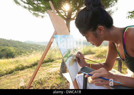 Giovane artista femminile pittura paesaggio, Buonconvento, Toscana, Italia Foto Stock