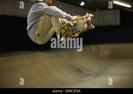 Giovane uomo fare skateboard trick Foto Stock