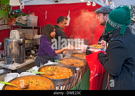 Giovane donna che serve cibo di strada marocchino sul mercato stand stand York North Yorkshire Inghilterra Regno Unito GB Gran Bretagna Foto Stock