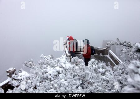 Huangshan, cinese della provincia di Anhui. 6 Mar 2014. Un turista prende le foto della neve scenario in montagna Huangshan, est cinese della provincia di Anhui, 6 marzo 2014. Credito: Shi Guangde/Xinhua/Alamy Live News Foto Stock