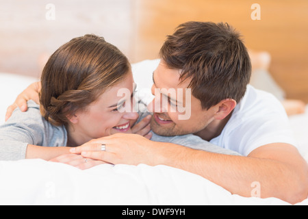 Felice coppia giacendo su un letto Foto Stock