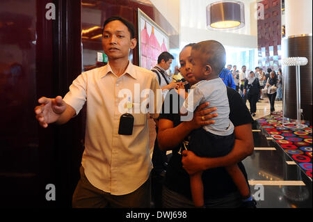 Putrajaya, MYS. Decimo Mar, 2014. I familiari dei passeggeri a bordo di un piano mancante essendo scortato lontano per la sicurezza in un hotel in Putrjaya, al di fuori di Kuala Lumpur, Malesia, Sabato, 10 marzo 2014. Radar militari indica che manca il Boeing 777 getto di Malaysia Airlines può avere ruotato indietro, Malaysia Air force chief detto Domenica decine e decine di navi e di aeromobili di tutta l'Asia riprende una battuta di caccia per il piano e la sua 239 passeggeri. Credito: Joshua Paul/NurPhoto/ZUMAPRESS.com/Alamy Live News Foto Stock