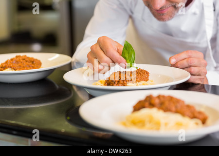 Primo piano di un maschio di chef la farcitura di prodotti alimentari Foto Stock