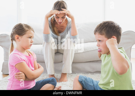 Stufi madre ascoltando la sua giovane bambini lotta Foto Stock