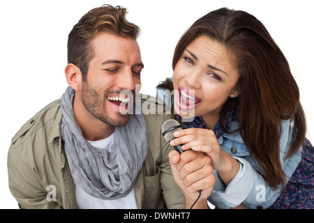 Ritratto di una giovane coppia di cantare nel microfono Foto Stock