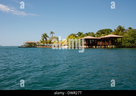 Honduras, dell Honduras Isole della baia, Roatan, Sandy Bay, Anthony's chiave. Resort bungalows lungo la scenic tropical Caye. Foto Stock