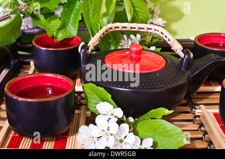 Il tè verde in una coppa in ceramica, teiera ceramica, Sakura chery Foto Stock