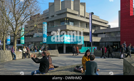 Per coloro che godono di sole primaverile al di fuori di Londra del Teatro Nazionale sulla banca del sud Foto Stock