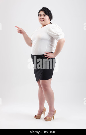 Una donna grassa in posa Foto Stock
