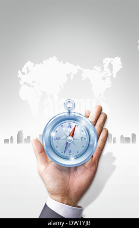 a business man holding a compass Foto Stock