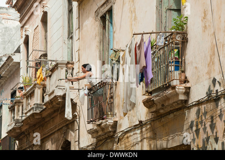 Donne appendere fuori per lavaggio a secco da balconi degli appartamenti a La Habana Vieja, Havana, Cuba Foto Stock