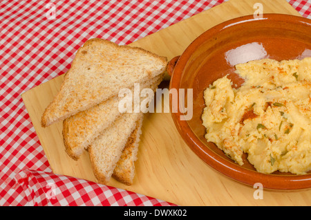 Un recipiente di argilla con freschi fatti in casa hummus Foto Stock