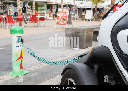 Renault Twizy alimentato a batteria auto elettrica inserita in un sol-lar la carica della batteria punto sulla strada in Isole Canarie Spagna Foto Stock