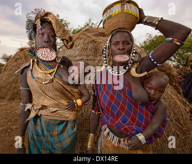 Le donne dei Mursi con piastre a labbro nella bassa valle dell'Omo di Etiopia. Foto Stock