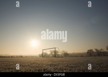 Vuoto di calcio e sul traguardo un gelido inverno mattina sunrise Foto Stock