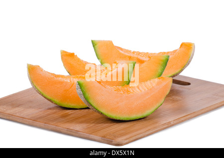 Melone fette di melone sul tagliere di legno Foto Stock