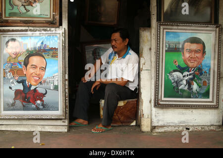 Jakarta, DKI Jakarta, Indonesia. Xix Mar, 2014. Un pittore si siede vicino al display di una pittura di Giacarta governatore Joko Widodo( seguente a sinistra), e un musicista Dangdut, Rhoma Irama (in basso a destra) a Street Painting Shop venditore in Jakarta. Marzo 19, 2014 . Joko Widodo chi è in esecuzione per il presidente per il Partito Democratico Indonesiano di Lotta (PDI-P) e Rhoma Irama un presidente candidato per il risveglio nazionale partito (CPC). Credito: Jeff Aries/ZUMAPRESS.com/Alamy Live News Foto Stock