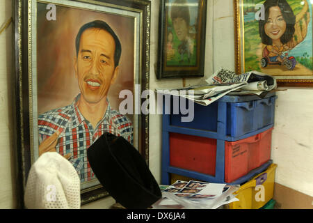 Jakarta, DKI Jakarta, Indonesia. Xix Mar, 2014. Un dipinto di Giacarta governatore Joko Widodo, chi è in esecuzione per il presidente per il Partito Democratico Indonesiano di Lotta (PDI-P) display a Street Painting Shop venditore in Jakarta. Marzo 19, 2014. Indonesia, il più grande del mondo a maggioranza musulmana con 250 milioni di persone, terrà i sondaggi legislativa nei mesi di aprile e di eleggere un nuovo presidente in luglio, con alcuni 180 milioni di elettori ammessi a partecipare. Credito: Jeff Aries/ZUMAPRESS.com/Alamy Live News Foto Stock