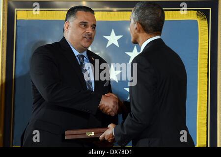 Il Presidente Usa Barack Obama presenta la medaglia d'onore di Richard Conde a nome di suo tardi padre, Sgt. 1. Classe Felix M. Conde-Falcon, uno dei 24 veterani dell esercito per ricevere il premio come parte del valor 24 cerimonia tenutasi alla Casa Bianca Marzo 18, 2014 a Washington D.C. Conde-Falcon, quindi un personale sergente, si distinse per atti di galanteria e intrepidity al di sopra e al di là della chiamata in Ap Tan Hoa, Repubblica del Vietnam il 4 aprile 1969. Foto Stock