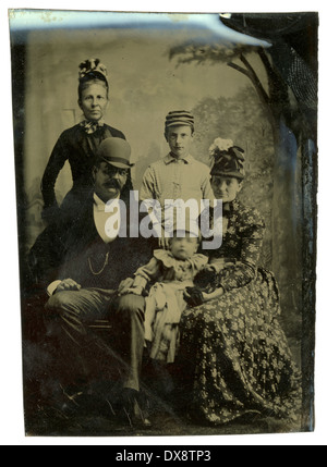 Nel 1860 circa antico tipo di stagno fotografia, famiglia di quattro con la nonna nel periodo dell'abbigliamento. Foto Stock